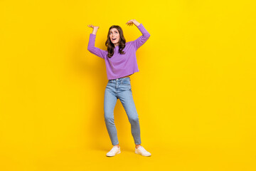 Fototapeta na wymiar Full size portrait of impressed hardworking girl arms hold heavy empty space isolated on yellow color background