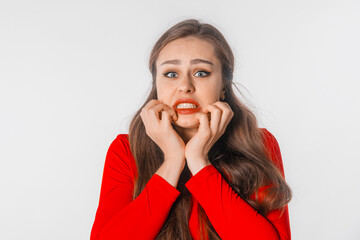 Portrait of young scared woman. Amazed horrified female keeps hands on mouth, being shocked to be expelled from university, look at camera, stand over white studio background