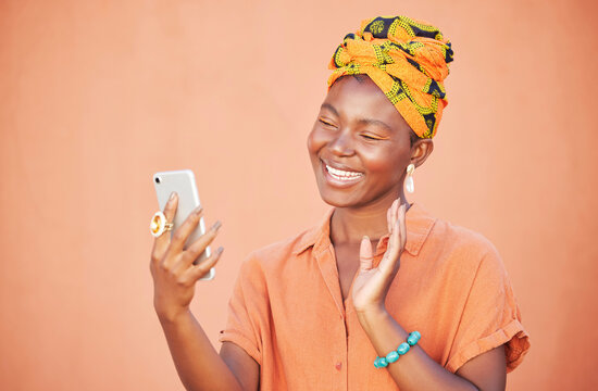 Black Woman, Phone And Video Call, Wave And Communication Outdoor Against Peach Wall Outdoor. Girl, Fashion And Virtual Conversation, Video Conference And Happy Smile Or Talking With Smartphone