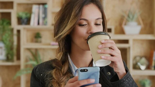Coffee shop, smartphone and student with online news, university results and app notification success for scholarship. Cafe, coffee cup drink and cellphone of college girl for internet inspiration
