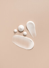 cosmetic smears of creamy texture on a beige background 
