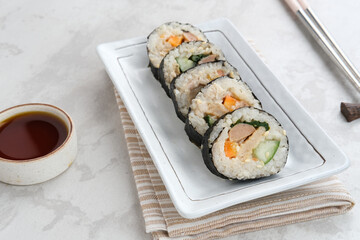 Korean Rolled Gimbap, made of rice, cucumber, tuna, carrot, sausage, crab stick and wrapped with seaweed laver. 
