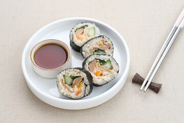 Korean Rolled Gimbap, made of rice, cucumber, tuna, carrot, sausage, crab stick and wrapped with seaweed laver. 
