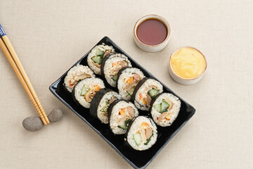 Korean Rolled Gimbap, made of rice, cucumber, tuna, carrot, sausage, crab stick and wrapped with seaweed laver. 
