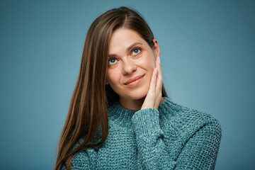 Smiling woman touching face and looking up. Isolated female face close up portrait