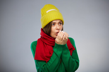 Sick woman in casual warm clothes and yellow hat isolated portrait.