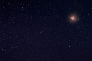 Fototapeta na wymiar Single bright star in the sky on Christmas Eve