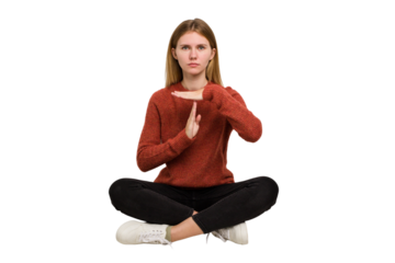Young caucasian woman sitting on the floor cutout isolated
