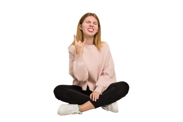 Fototapeta premium Young caucasian woman sitting on the floor cutout isolated