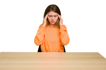 Young caucasian woman sitting on a chair in a desktop isolated touching temples and having headache.