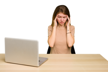 Young caucasian woman in a workplace working with a laptop isolated touching temples and having headache.