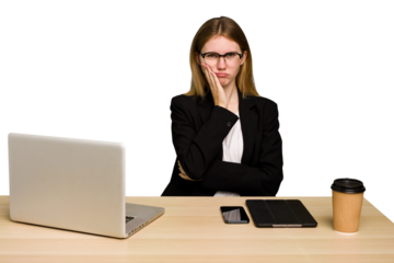 Young business caucasian woman working on her workplace cutout isolated who is bored, fatigued and need a relax day.