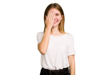 Young caucasian woman isolated having fun covering half of face with palm.