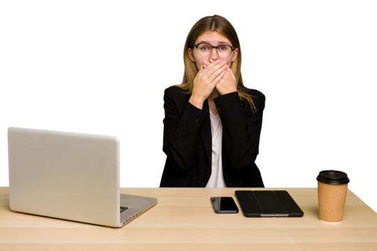 Young business caucasian woman working on her workplace cutout isolated covering mouth with hands looking worried.