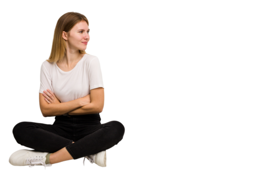 Young caucasian woman sitting on the floor cutout isolated