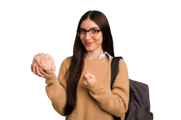 Young caucasian student woman holding a brain isolated pointing with finger at you as if inviting come closer.