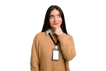 Young caucasian woman with ID card isolated looking sideways with doubtful and skeptical expression.