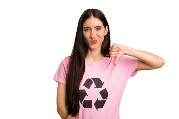 Young caucasian woman wearing a recycling t-shirt isolated showing a dislike gesture, thumbs down....