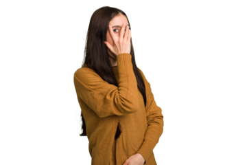 Young caucasian brunette long hair woman cutout isolated blink through fingers frightened and nervous.