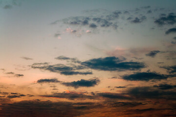 Summer evening sky in the picturesque clouds, lit by the rays of the setting sun.