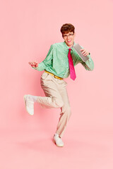 Fun, joy. Creative portrait of stylish emotional man, student geek wearing vintage style shirt and...