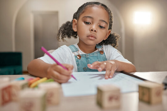 Girl, homework and writing on paper, learning and homeschool with math, education and knowledge at table in home. Latino child or student in brazil with concentration, school work and study in house