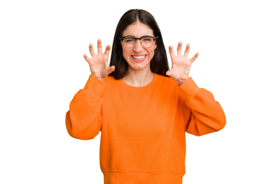 Young caucasian brunette long hair woman cutout isolated showing claws imitating a cat, aggressive gesture.