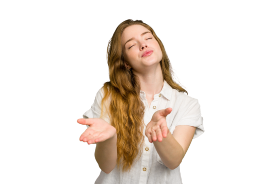 Young caucasian redhead woman isolated folding lips and holding palms to send air kiss.