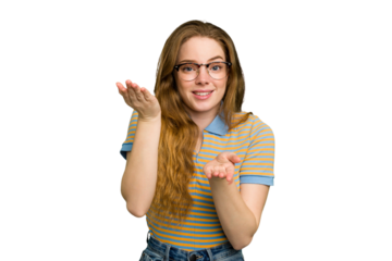 Young caucasian redhead woman isolated makes scale with arms, feels happy and confident.