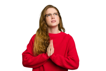 Young caucasian redhead woman isolated holding hands in pray near mouth, feels confident.