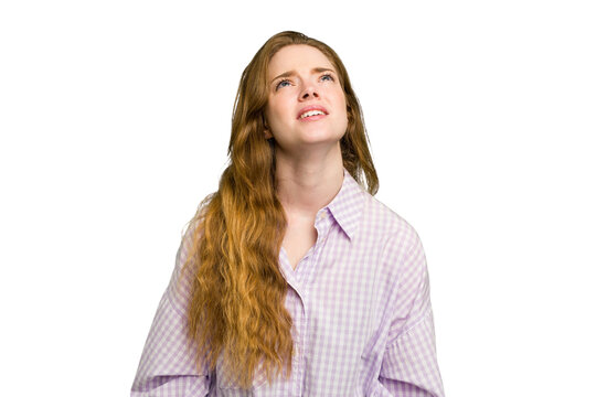Young caucasian redhead woman isolated shouting very angry, rage concept, frustrated.