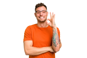 Young caucasian handsome man isolated winks an eye and holds an okay gesture with hand.