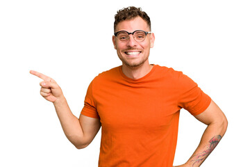 Young caucasian handsome man isolated smiling cheerfully pointing with forefinger away.