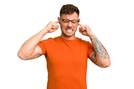 Young caucasian handsome man isolated covering ears with fingers, stressed and desperate by a loudly ambient.