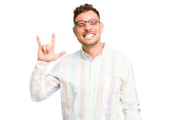 Naklejka premium Young caucasian handsome man isolated showing a horns gesture as a revolution concept.