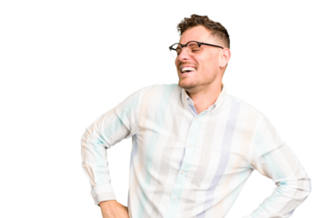 Young caucasian handsome man isolated laughs happily and has fun keeping hands on stomach.