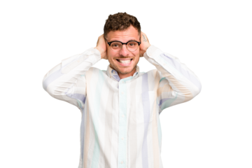 Young caucasian handsome man isolated covering ears with hands trying not to hear too loud sound.