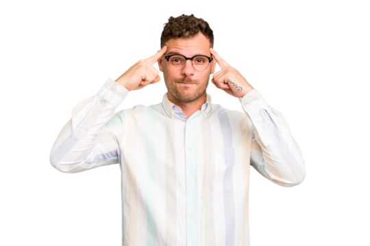 Young caucasian handsome man isolated focused on a task, keeping forefingers pointing head.