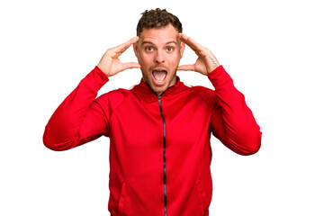 Young caucasian handsome man isolated receiving a pleasant surprise, excited and raising hands.