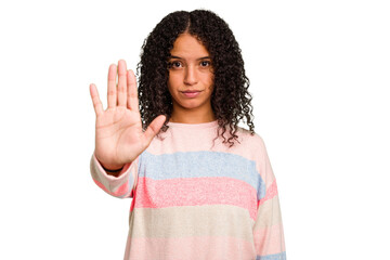 Young Brazilian curly hair cute woman isolated standing with outstretched hand showing stop sign,...