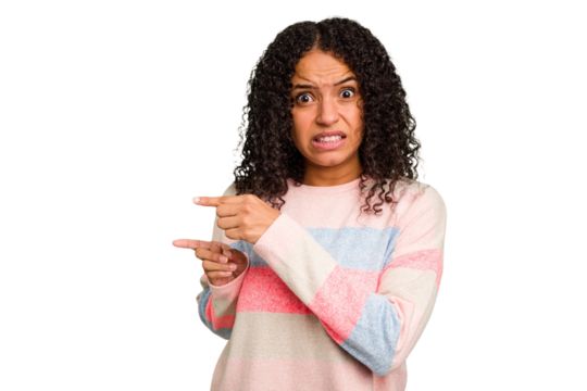 Young Brazilian curly hair cute woman isolated shocked pointing with index fingers to a copy space.