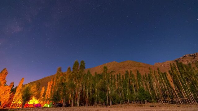 large meteor between at 6 second and campsite among the trees. north of Iran, Alborz mountains.the video took several hours to record.the direction of the shadows changing due to the moon's movement.