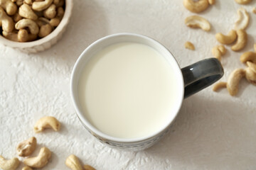 Fototapeta na wymiar Vegan cashew milk in a cup on a table