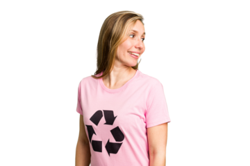 Young caucasian woman wearing a recycling t-shirt isolated looks aside smiling, cheerful and pleasant.