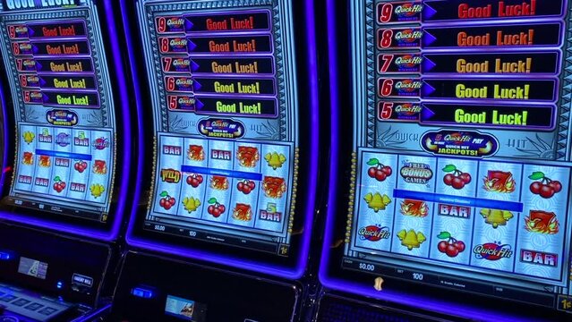 Colorful lights on slot machines with good luck message on cruise ship casino
