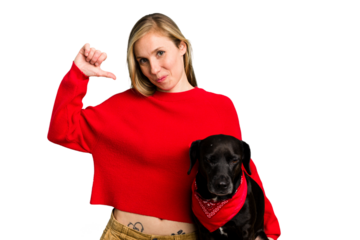 Young caucasian woman and her dog isolated feels proud and self confident, example to follow.