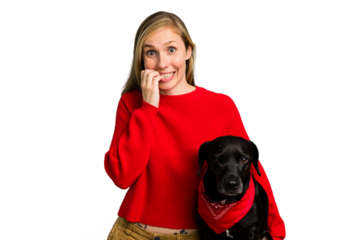 Young caucasian woman and her dog isolated biting fingernails, nervous and very anxious.
