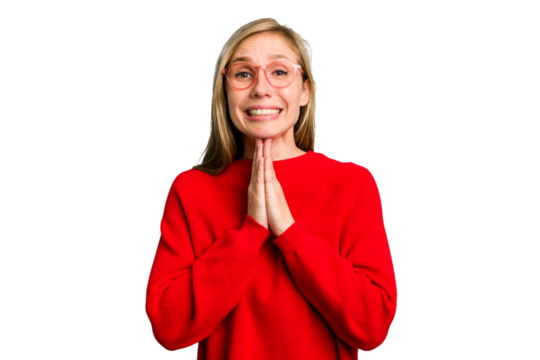 Young caucasian woman cutout isolated holding hands in pray near mouth, feels confident.