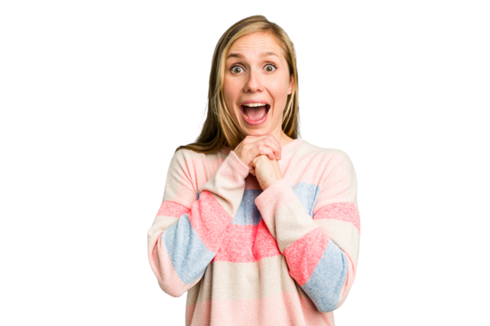 Young caucasian woman cutout isolated praying for luck, amazed and opening mouth looking to front.