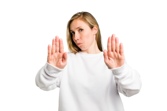 Young caucasian woman cutout isolated standing with outstretched hand showing stop sign, preventing you.
